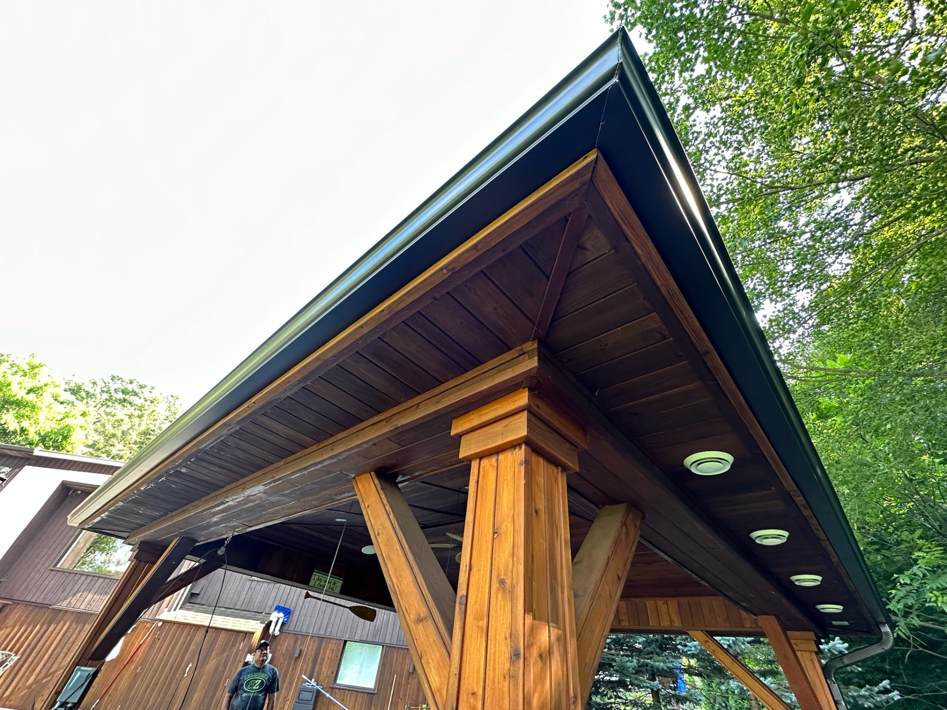Covered outdoor structure with finished fascia and eavestrough